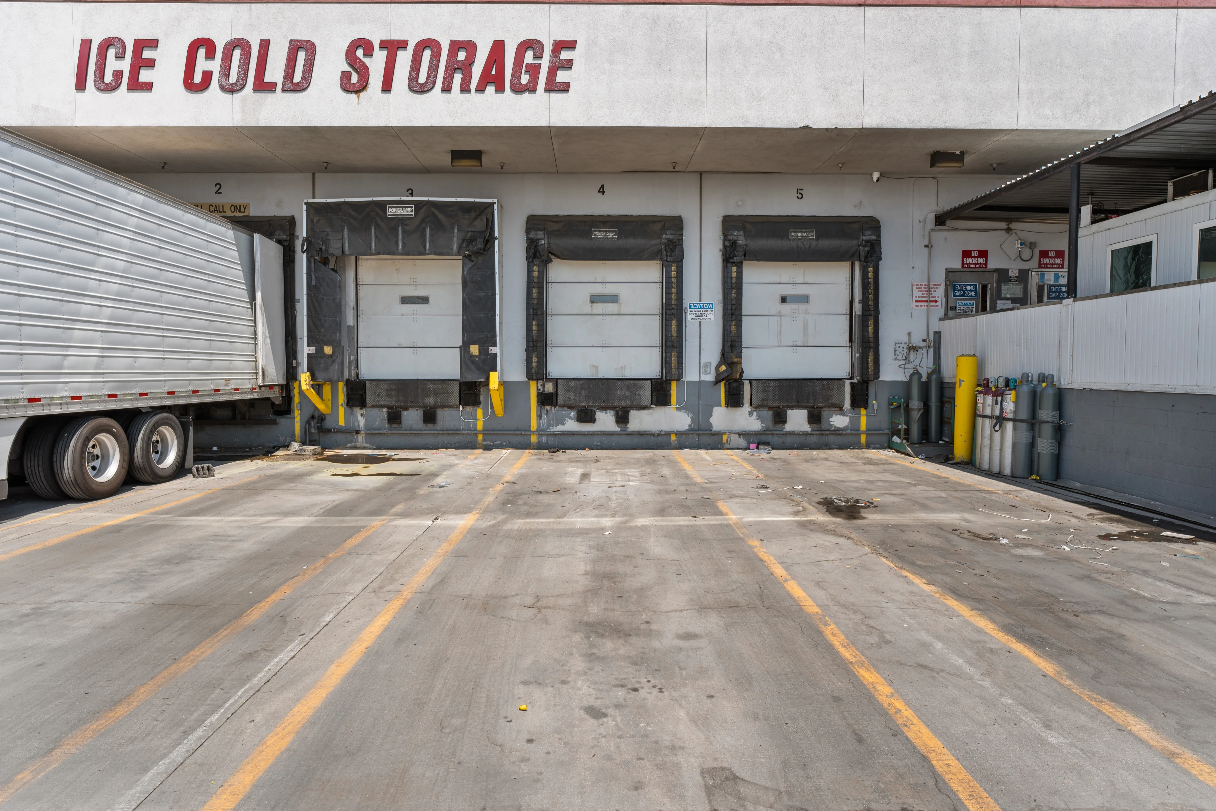 Dock Workers Unloading Reefer Containers Near Port